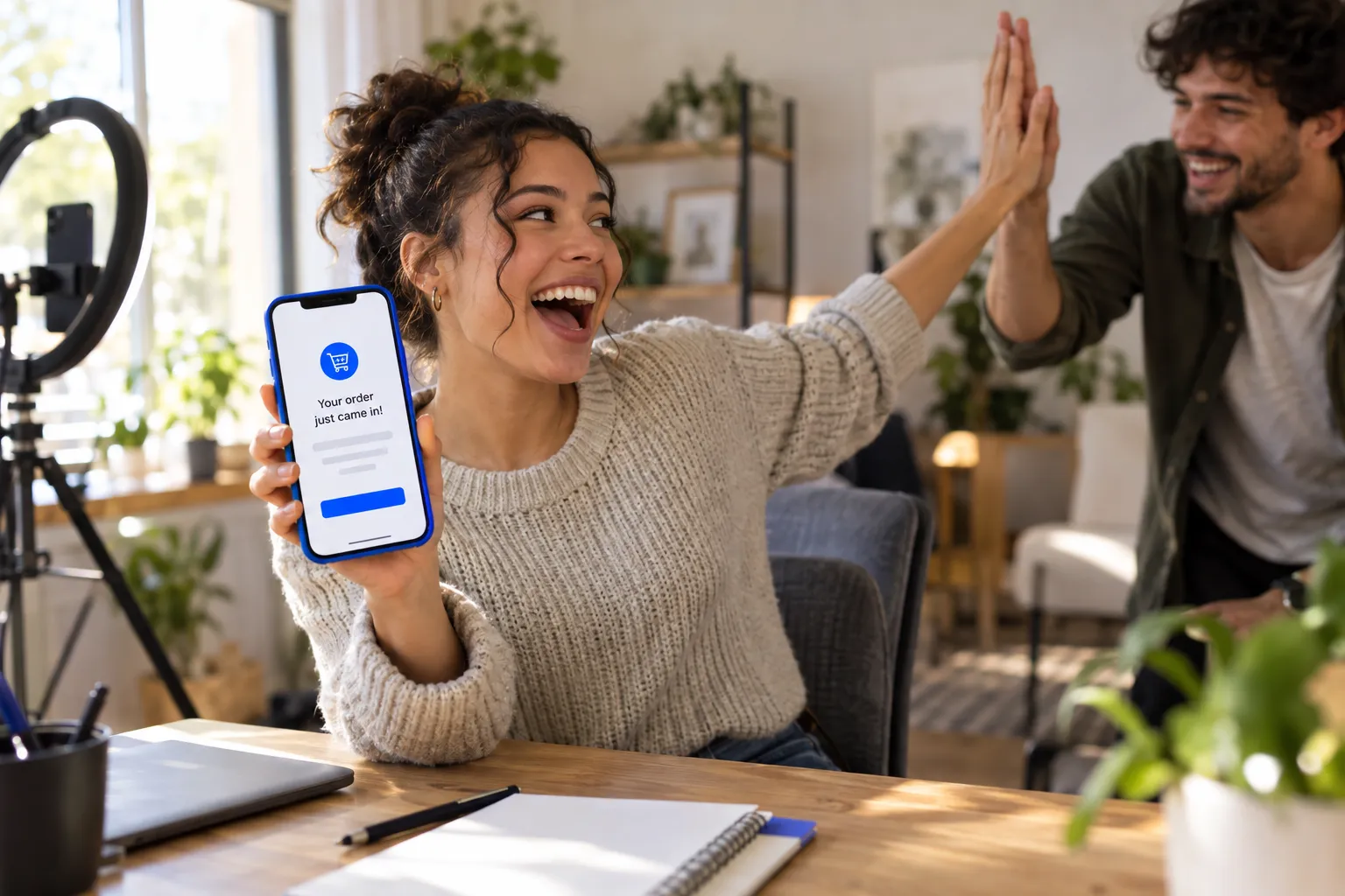 Young entrepreneur celebrating first affiliate sale on laptop at home desk